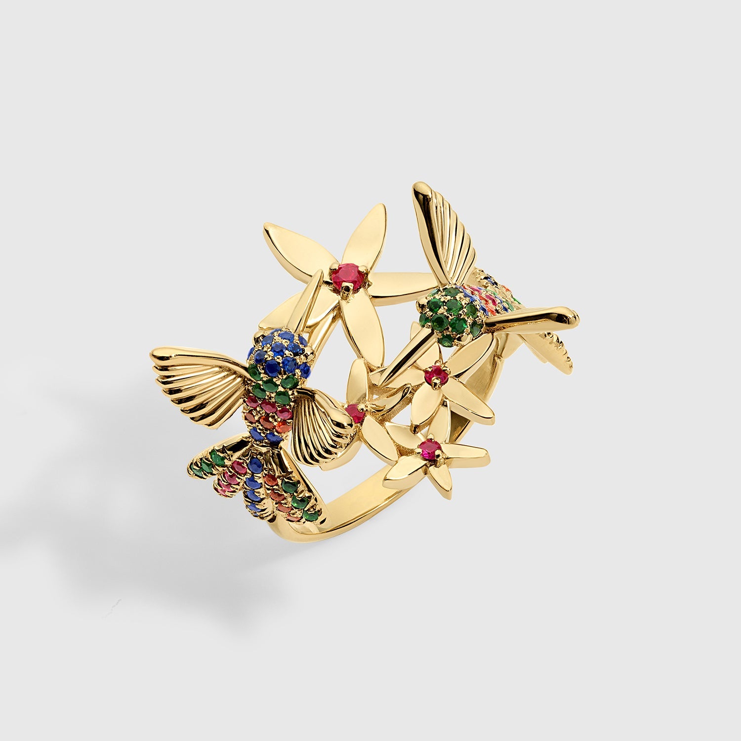 Rainbow Hummingbird ring in solid yellow gold featuring multicolored sapphires and rubies from the Humming Beauty collection by Aurora Laffite Jewelry.
