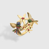 Rainbow Hummingbird ring in solid yellow gold featuring multicolored sapphires and rubies from the Humming Beauty collection by Aurora Laffite Jewelry.
