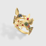 Rainbow Hummingbird ring in solid yellow gold featuring multicolored sapphires and rubies from the Humming Beauty collection by Aurora Laffite Jewelry.